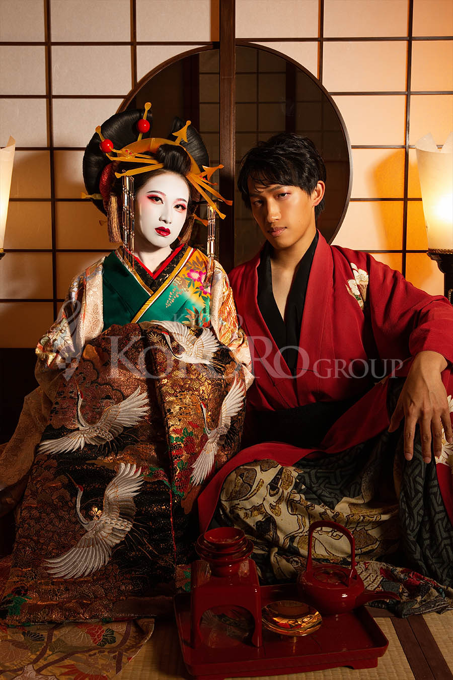 Couple enjoying a Classic Oiran experience in Kyoto in front of a traditional round window
